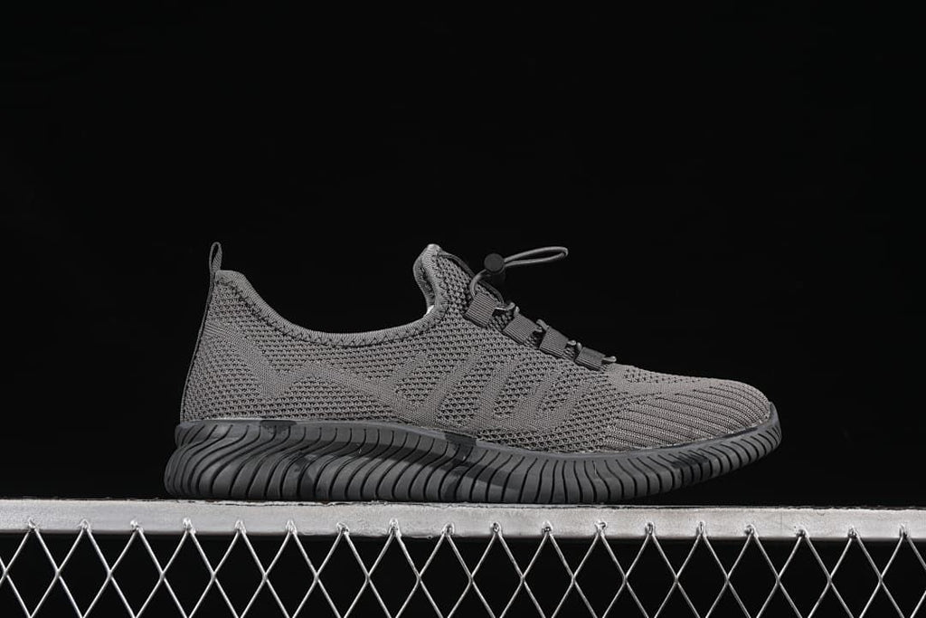 Side profile of the gray shoe with blue logo accents