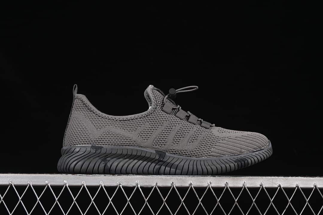 Side profile of the gray shoe with blue logo accents