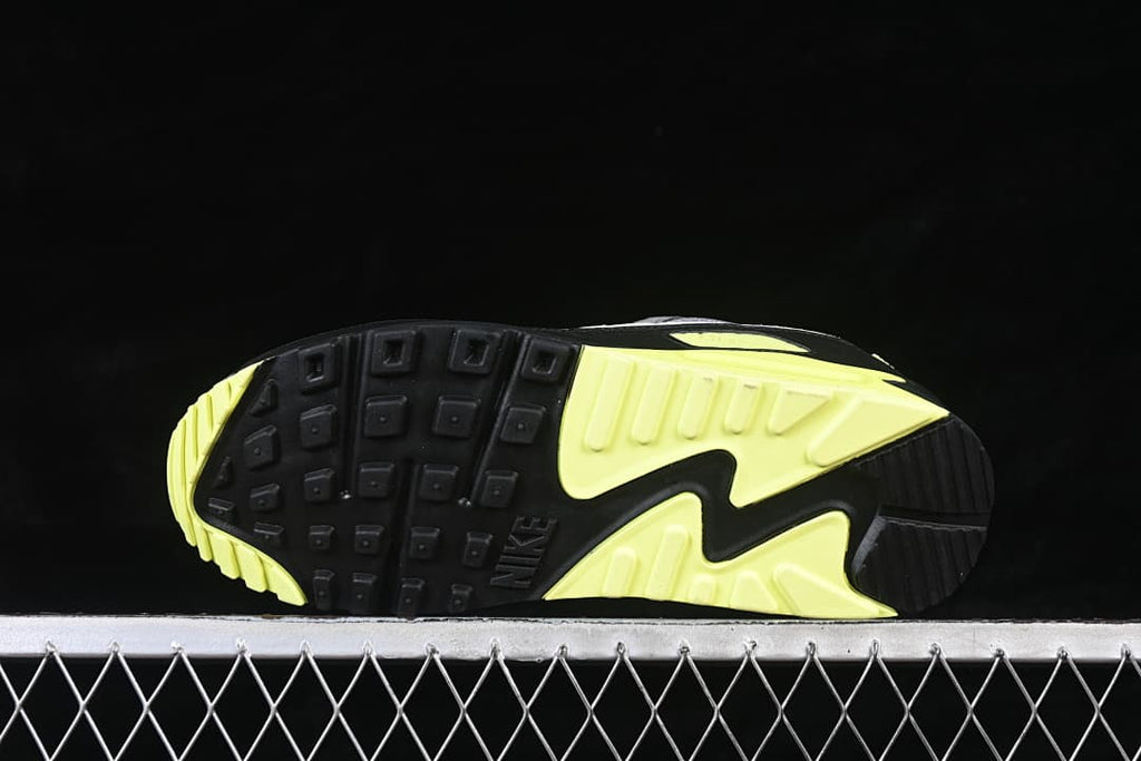 Underside of the Nike Air Max 90 showing its black and volt patterned outsole.