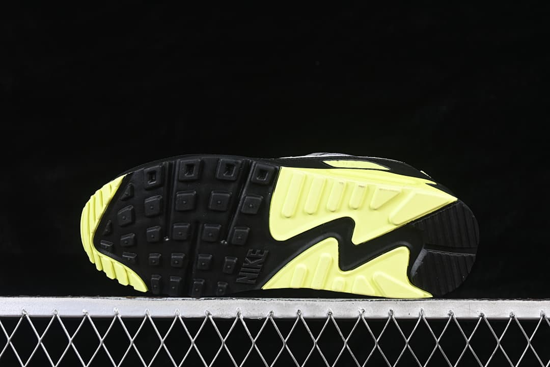 Underside of the Nike Air Max 90 showing its black and volt patterned outsole.