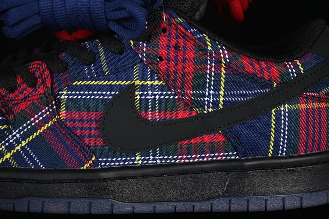 Close-up of the plaid side panels, black Swoosh, and dark sole.