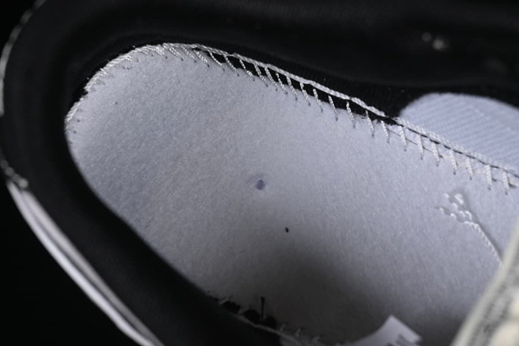 Close-up of the sneaker's grey interior lining and stitching