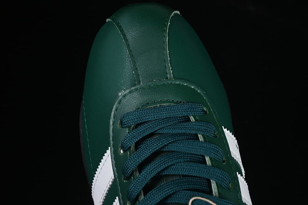 Top view of the green sneaker's toe and lacing.