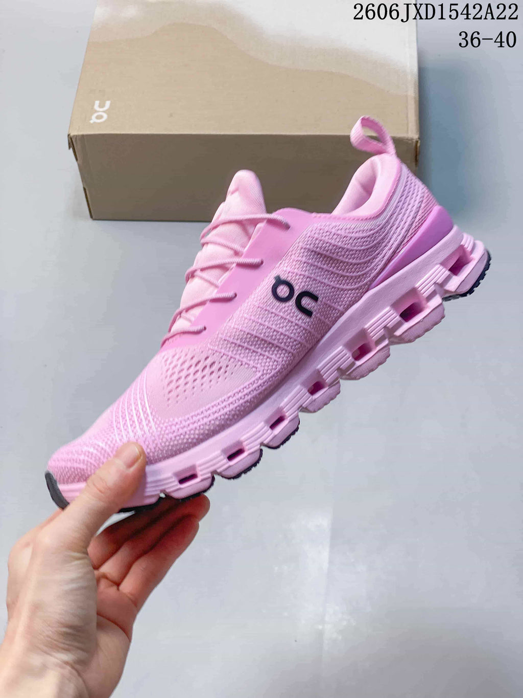 Side view of a pink sneaker with a segmented sole
