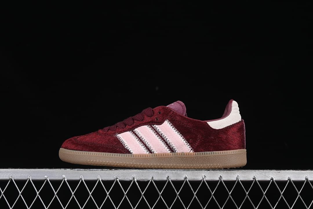 Side view of burgundy Adidas Samba OG sneakers with pale pink stripes and gum-colored sole
