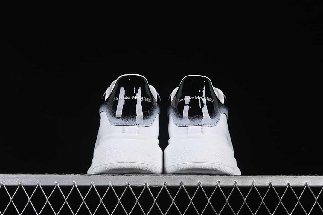 Rear view of both sneakers showing their gradient heel tabs