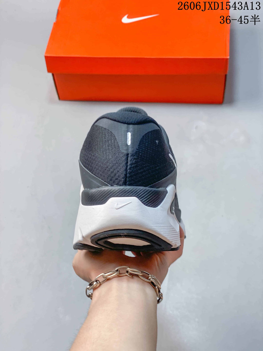 Rear view showing the heel and layered white and dark midsole.
