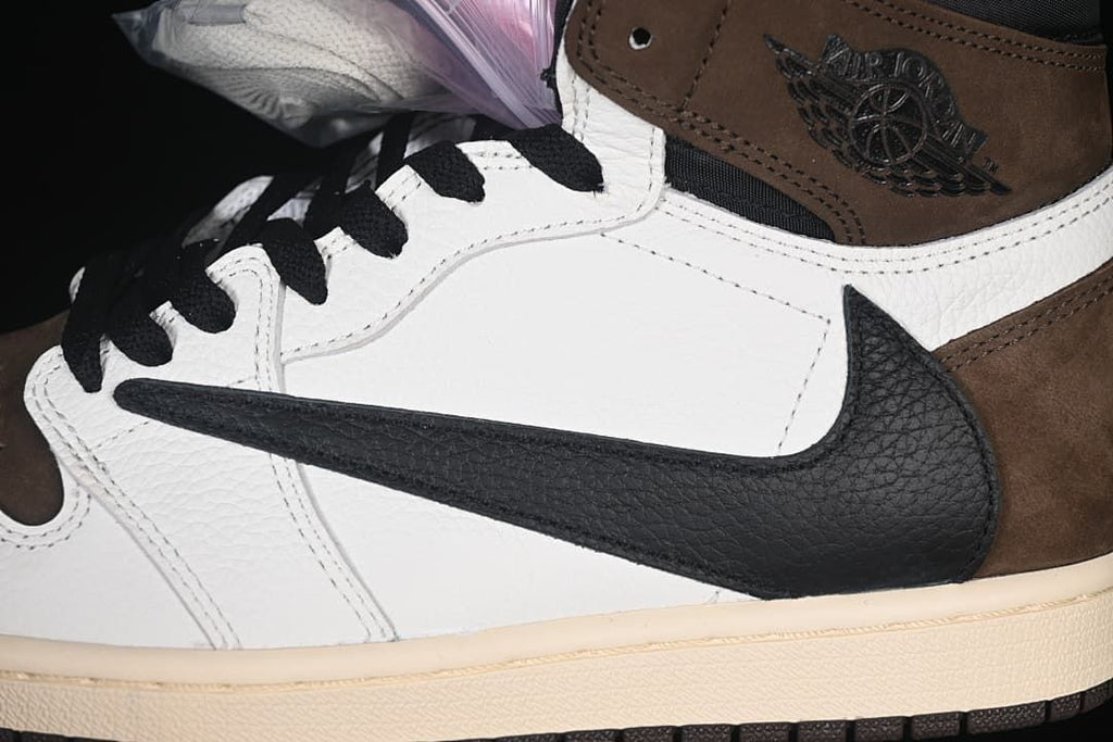 Close-up of the reverse-facing black Swoosh and brown ankle panel