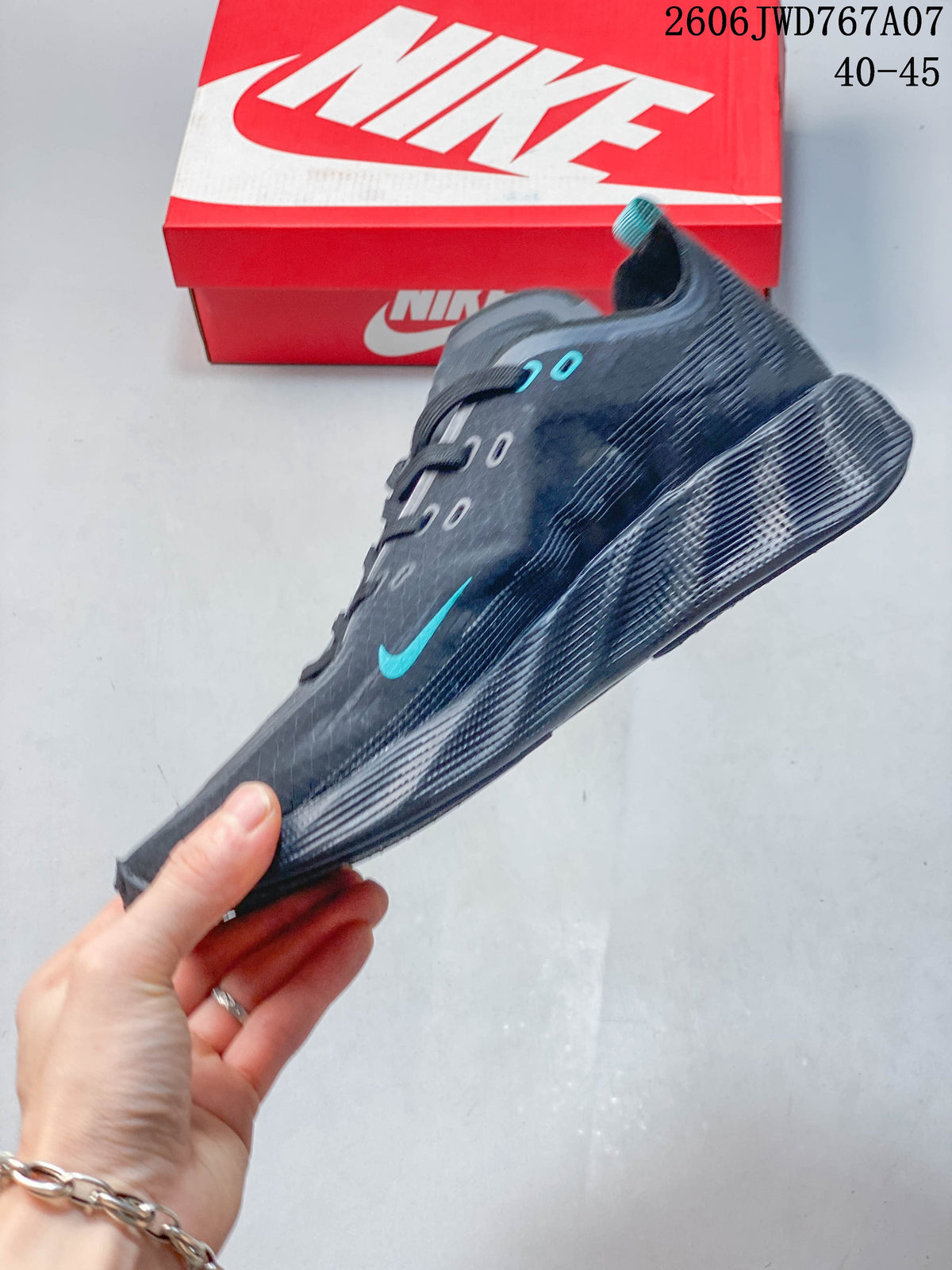 Side profile of the charcoal gray shoe with teal logo detail