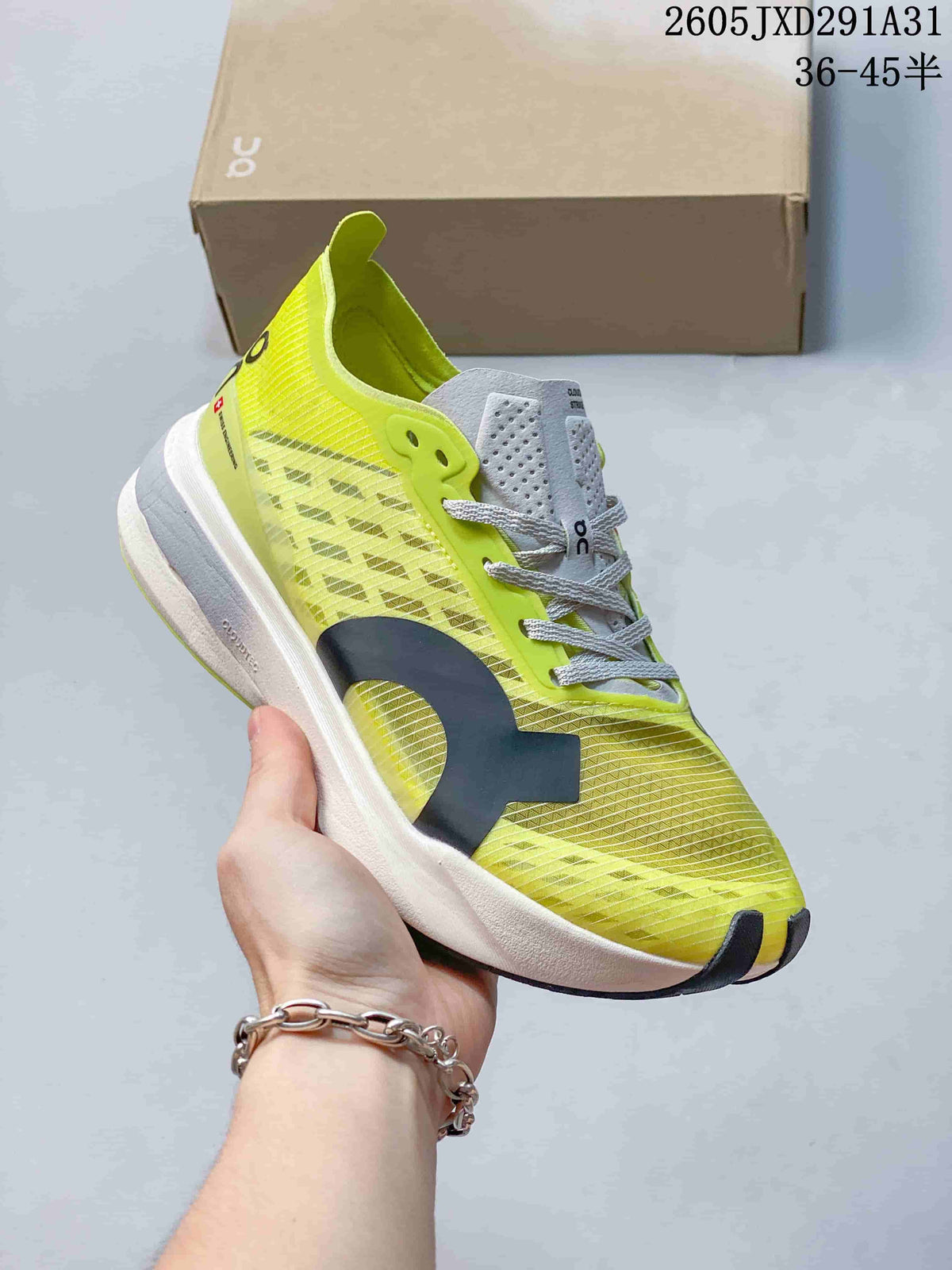 Angled side view of the yellow-green Cloudboom Strike running shoe.