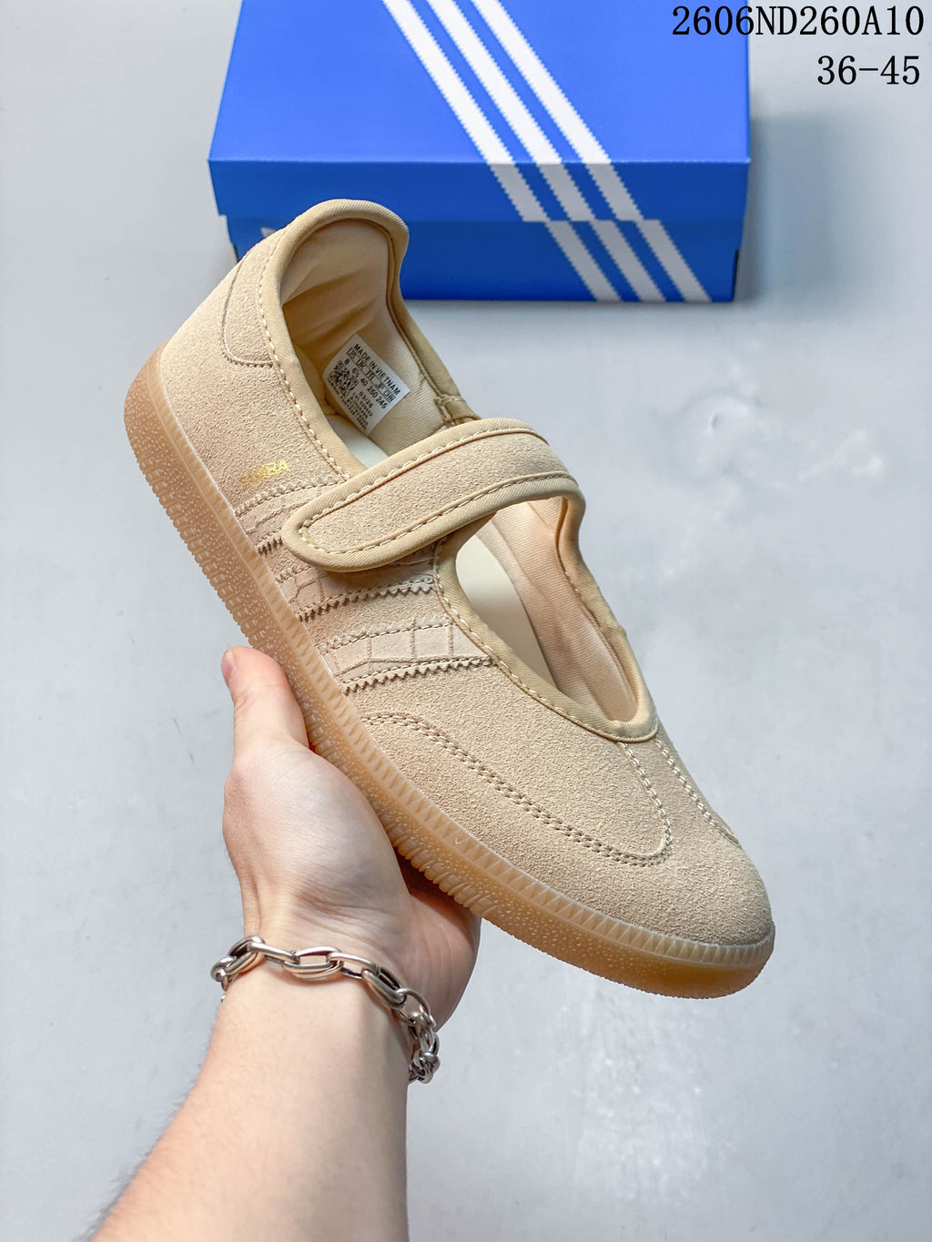Side view of a sand-beige Mary Jane shoe with a single strap and gum-colored outsole.