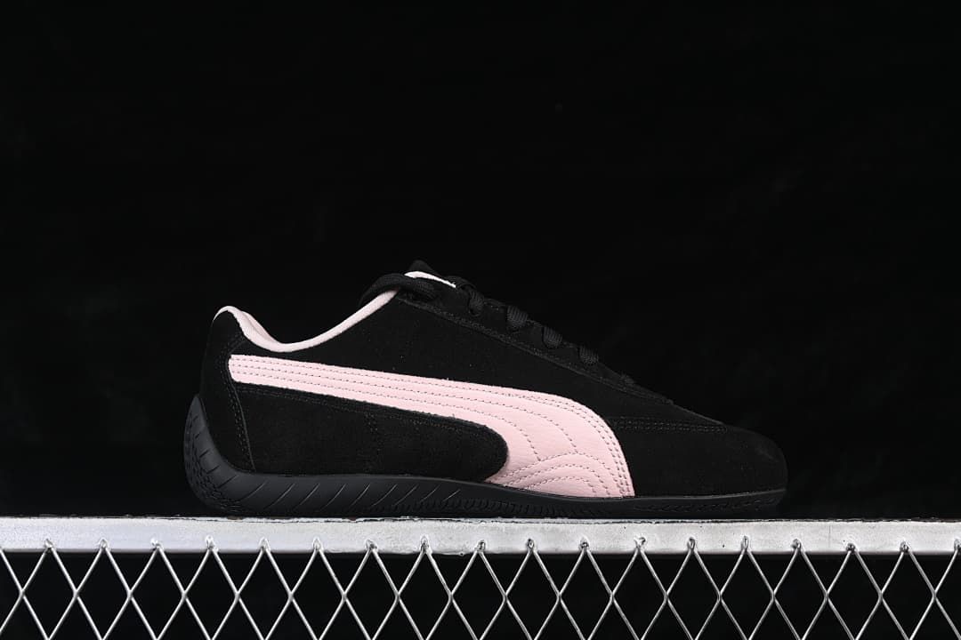 Side profile of the black sneaker with pale pink Formstrip detailing.