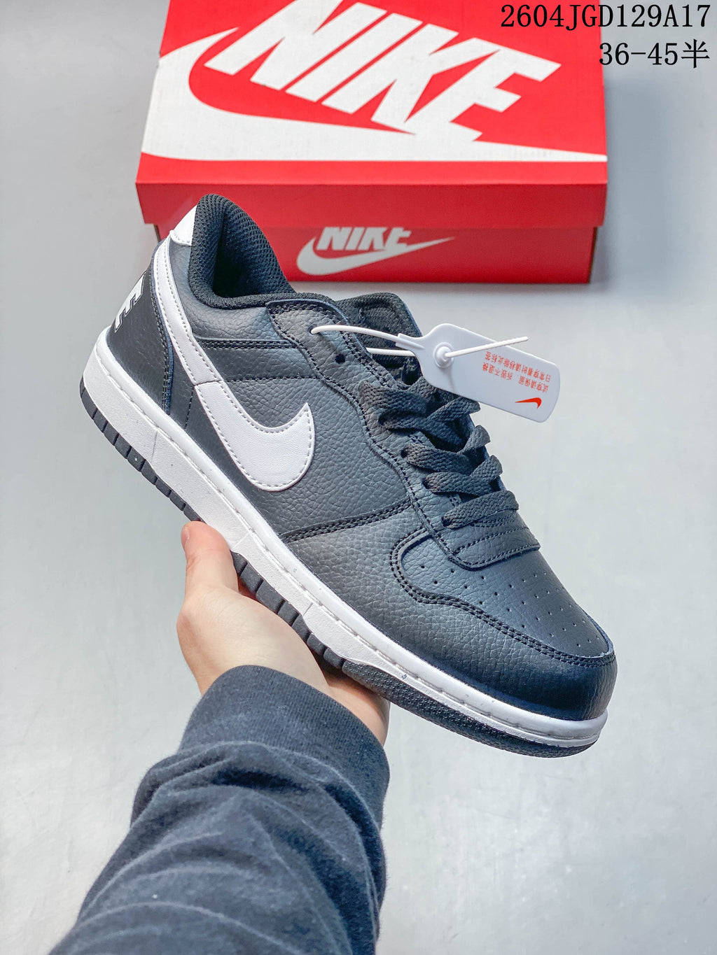 Angled side view of a dark gray Nike low-top sneaker with a white Swoosh