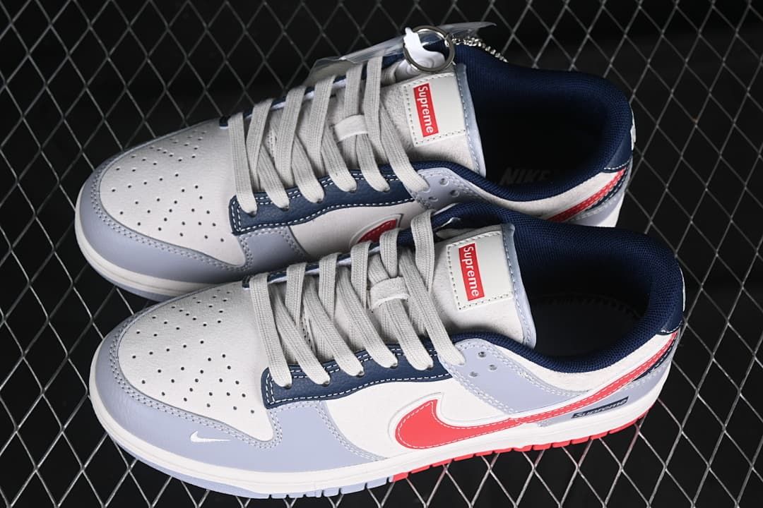 Pair of gray, white, navy and red low-top sneakers