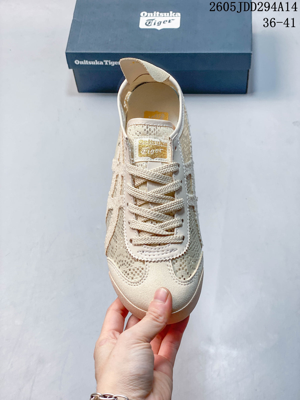 Front view of a cream lace-up sneaker with patterned panels