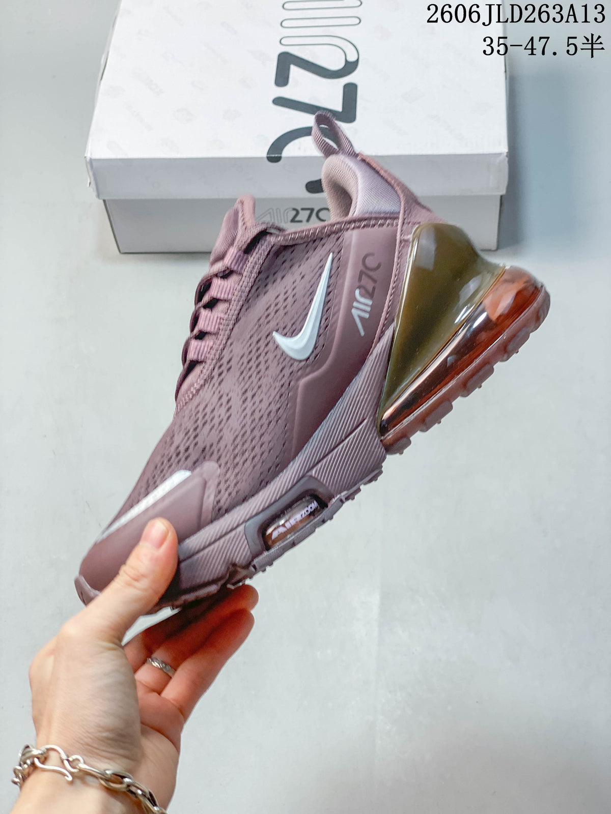 Side profile of the dusty pink sneaker with Swoosh and Air Max 270 details