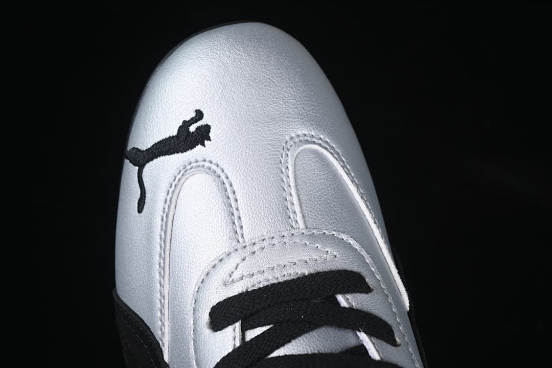 Top-down close-up of the silver toe, black Puma logo and laces.