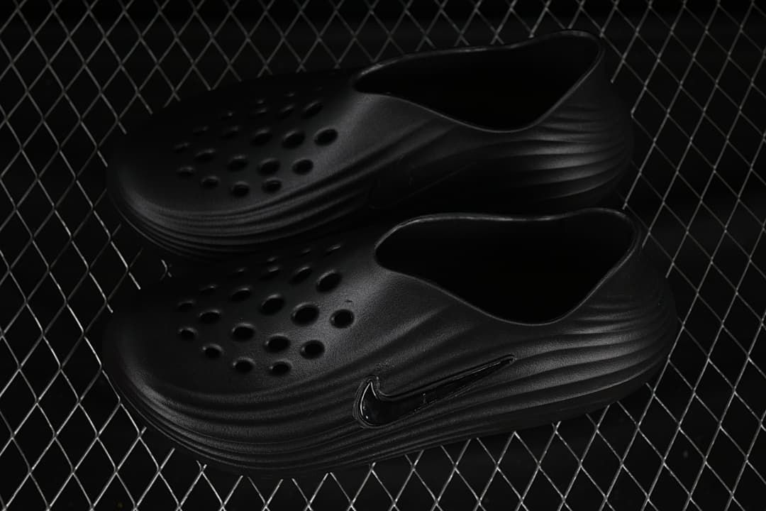 Pair of black closed-toe slides shown at an angle