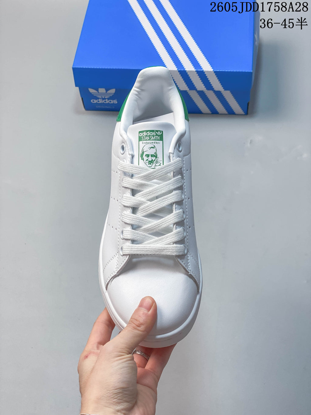 Front view showing white laces and green Stan Smith tongue label