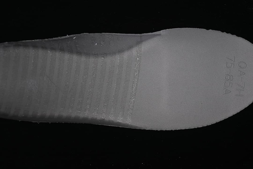 Close-up of the sneaker outsole with molded markings
