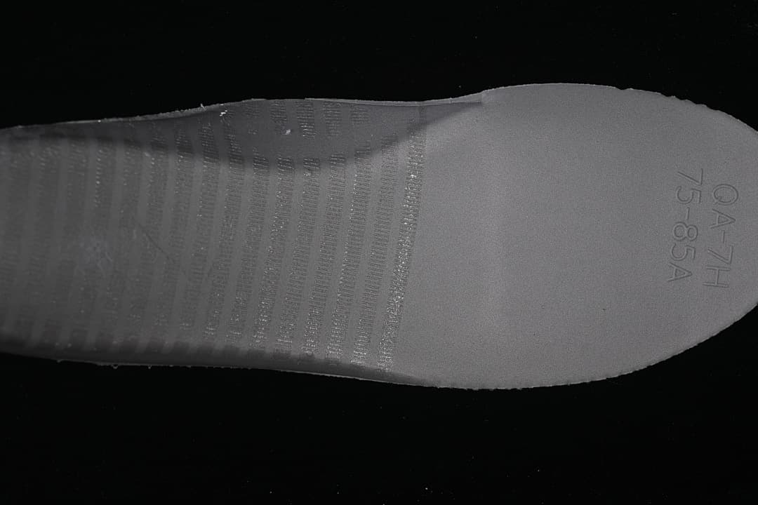 Close-up of the sneaker outsole with molded markings