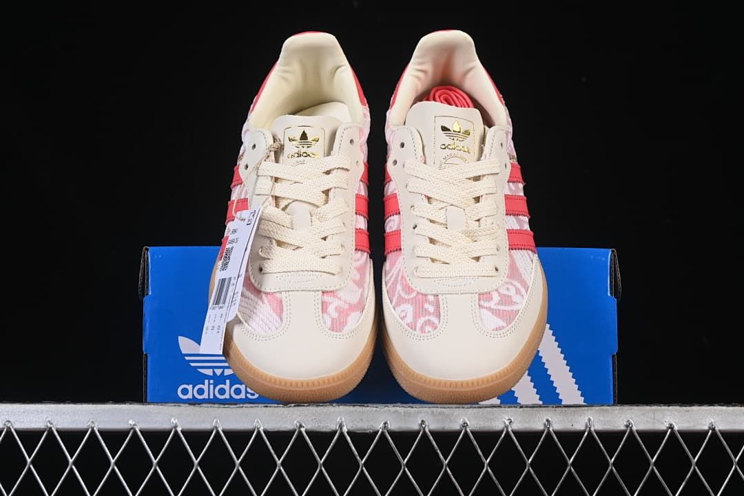 Front view of the pair displayed on an adidas shoebox