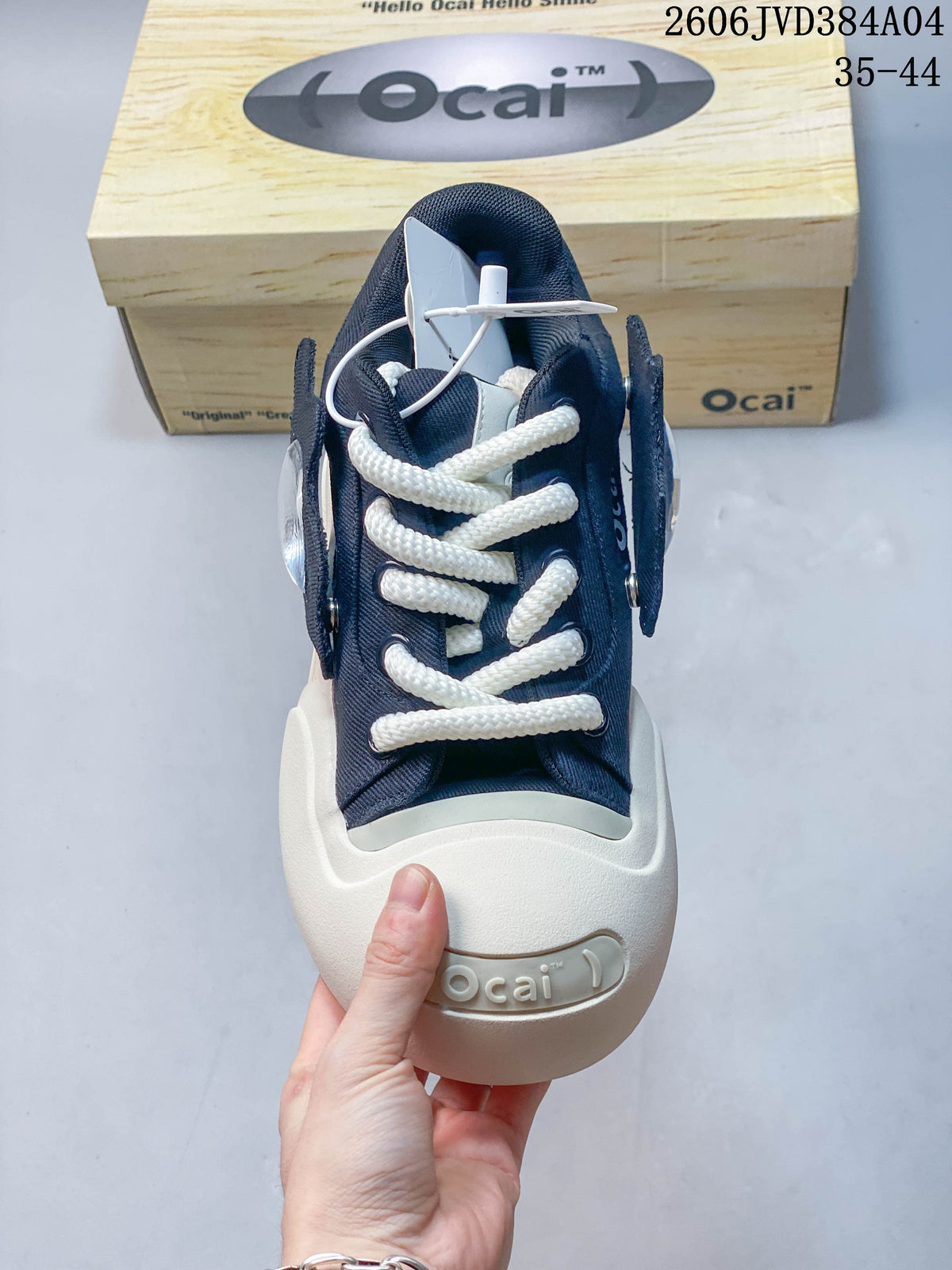Front view of a navy Ocai sneaker with thick white laces and a rounded toe