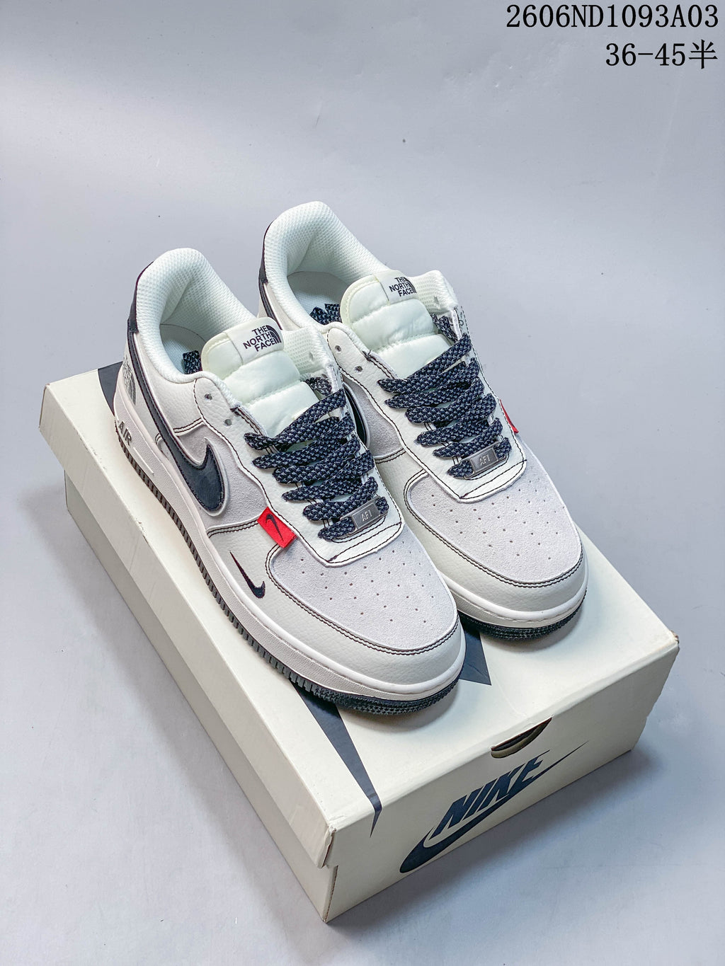 Pair of low-top sneakers with dark gray laces and side detailing