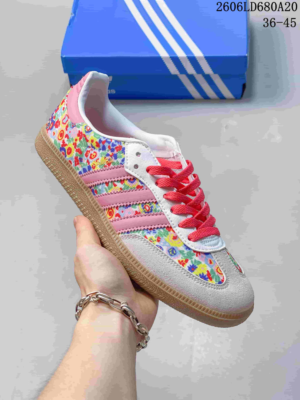Angled side view of the sneaker with floral print, pink stripes, and gum-colored sole