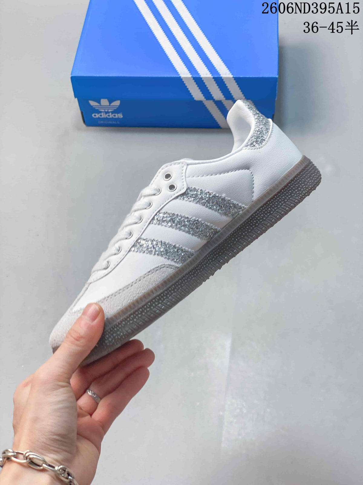 Side view of the white low-top sneaker with three silver glitter stripes