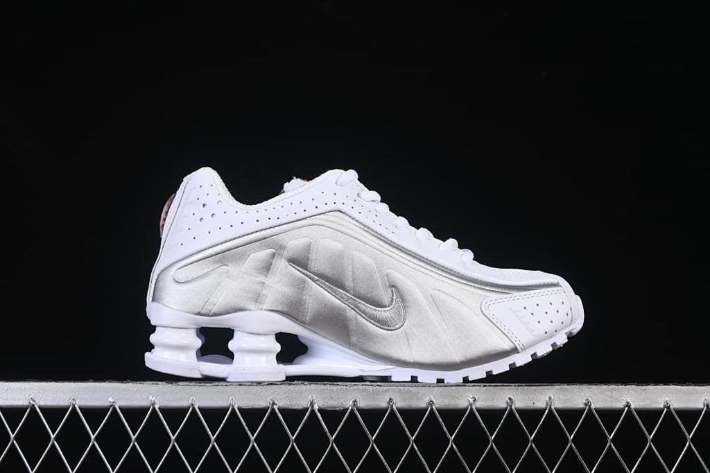 Side profile showing the metallic silver panel and Shox heel columns