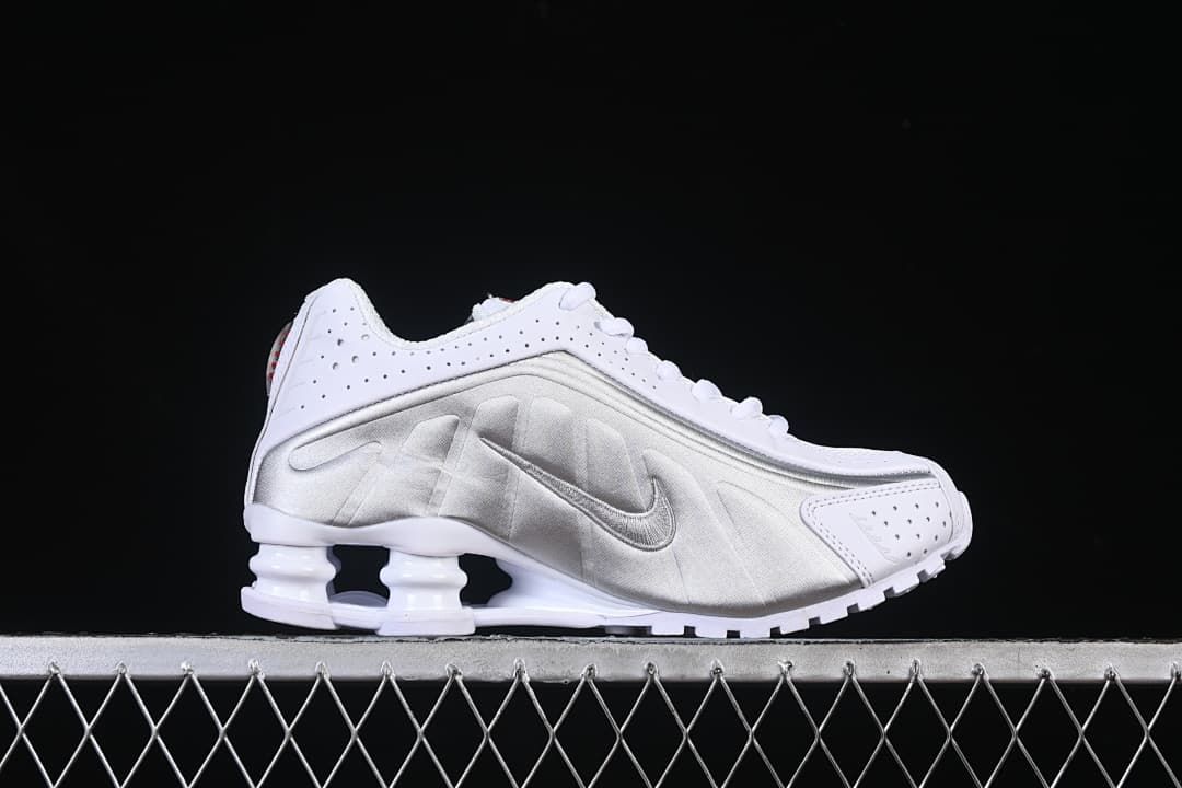 Side profile showing the metallic silver panel and Shox heel columns
