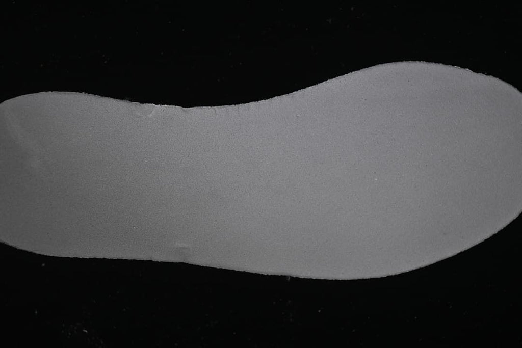Close-up of the sneaker's light-colored sole component