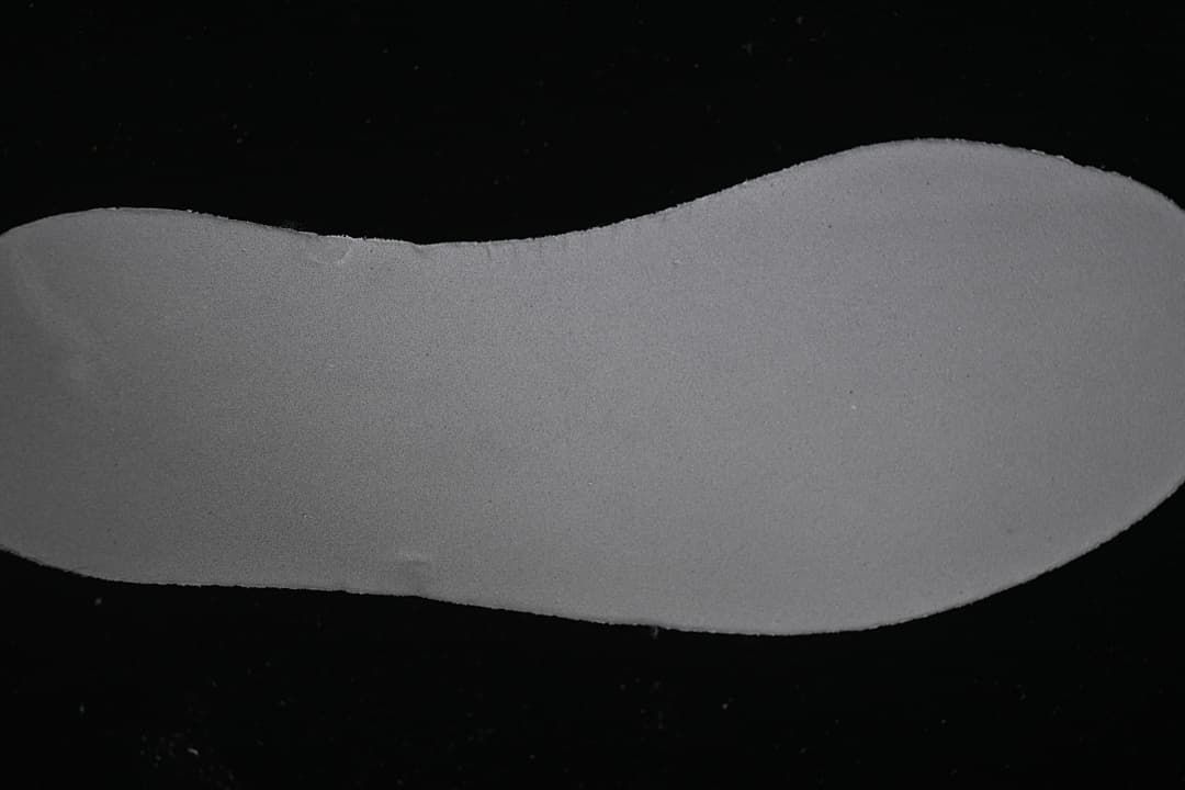 Close-up of the sneaker's light-colored sole component