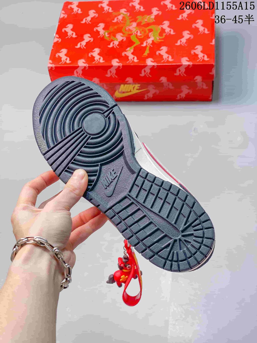 Close-up of the dark outsole and red patterned box