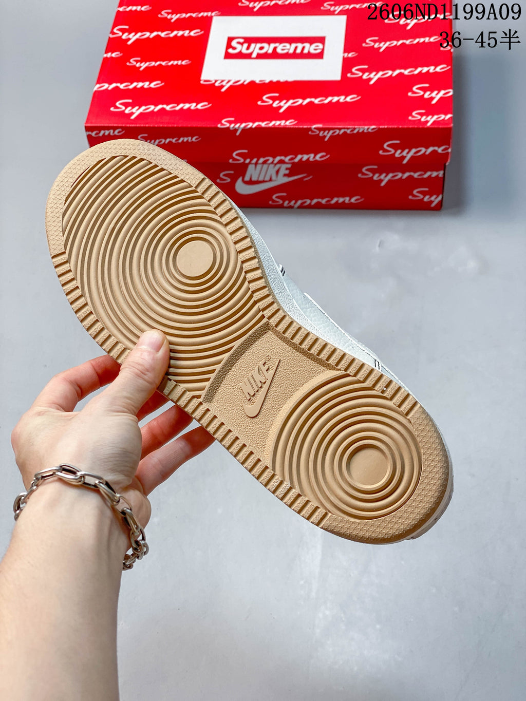 Close-up of the sneaker’s gum-colored outsole with circular traction pattern.