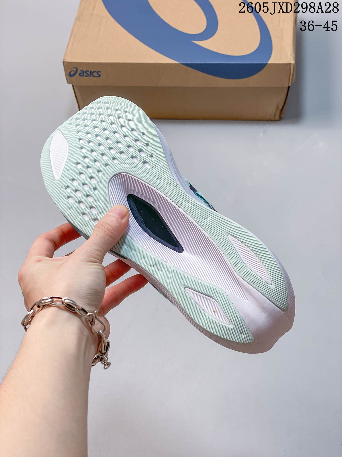 Underside of a mint running shoe showing its outsole and central insert