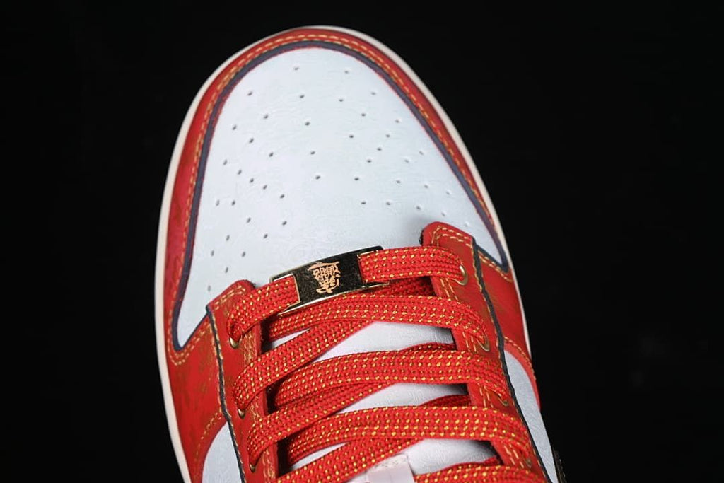 Top view of the perforated white toe and red laces