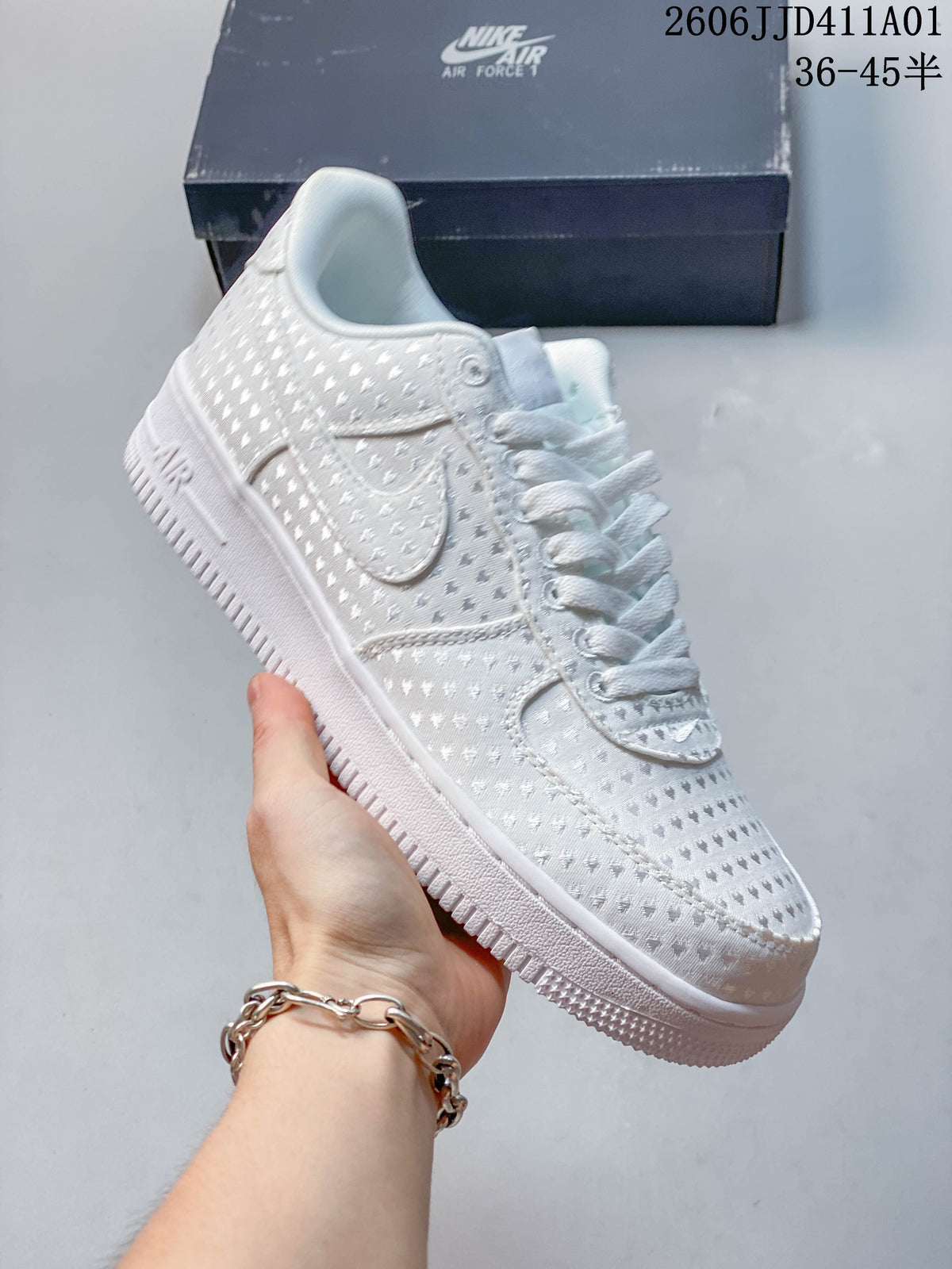 Side view of a white patterned Nike Air Force 1 low-top sneaker.