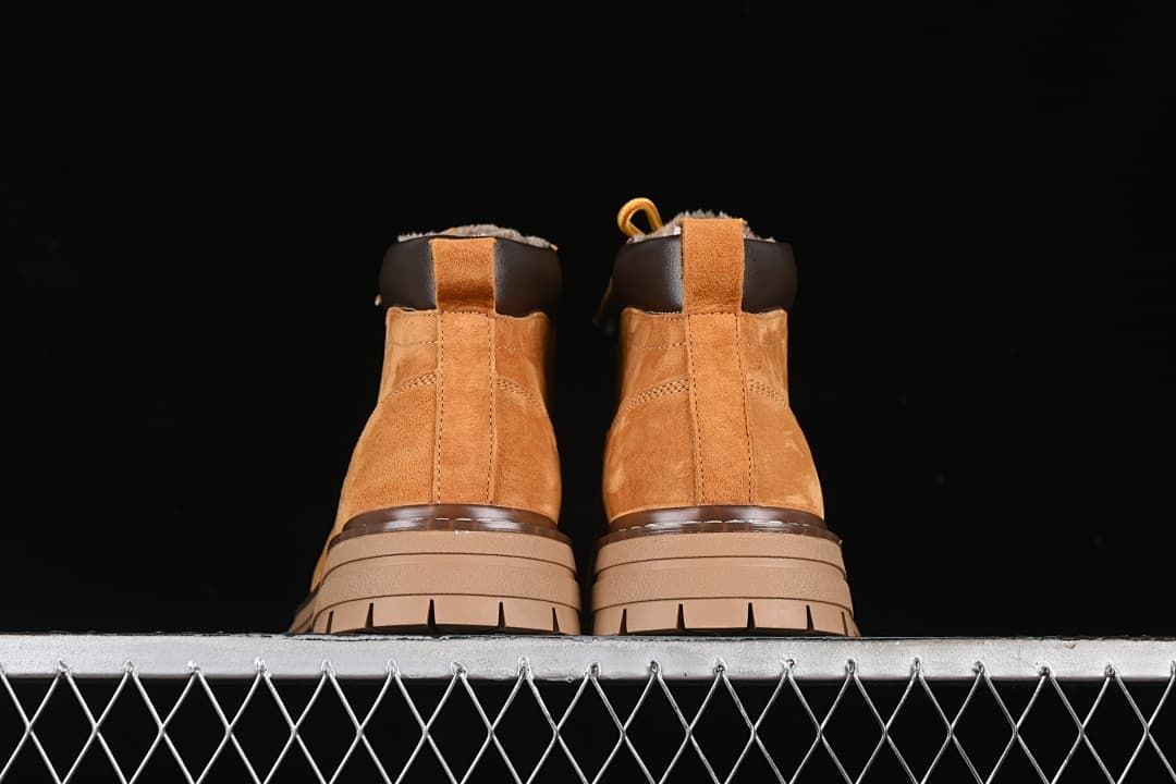 Rear view of the pair showing heel pulls and chunky lugged soles.