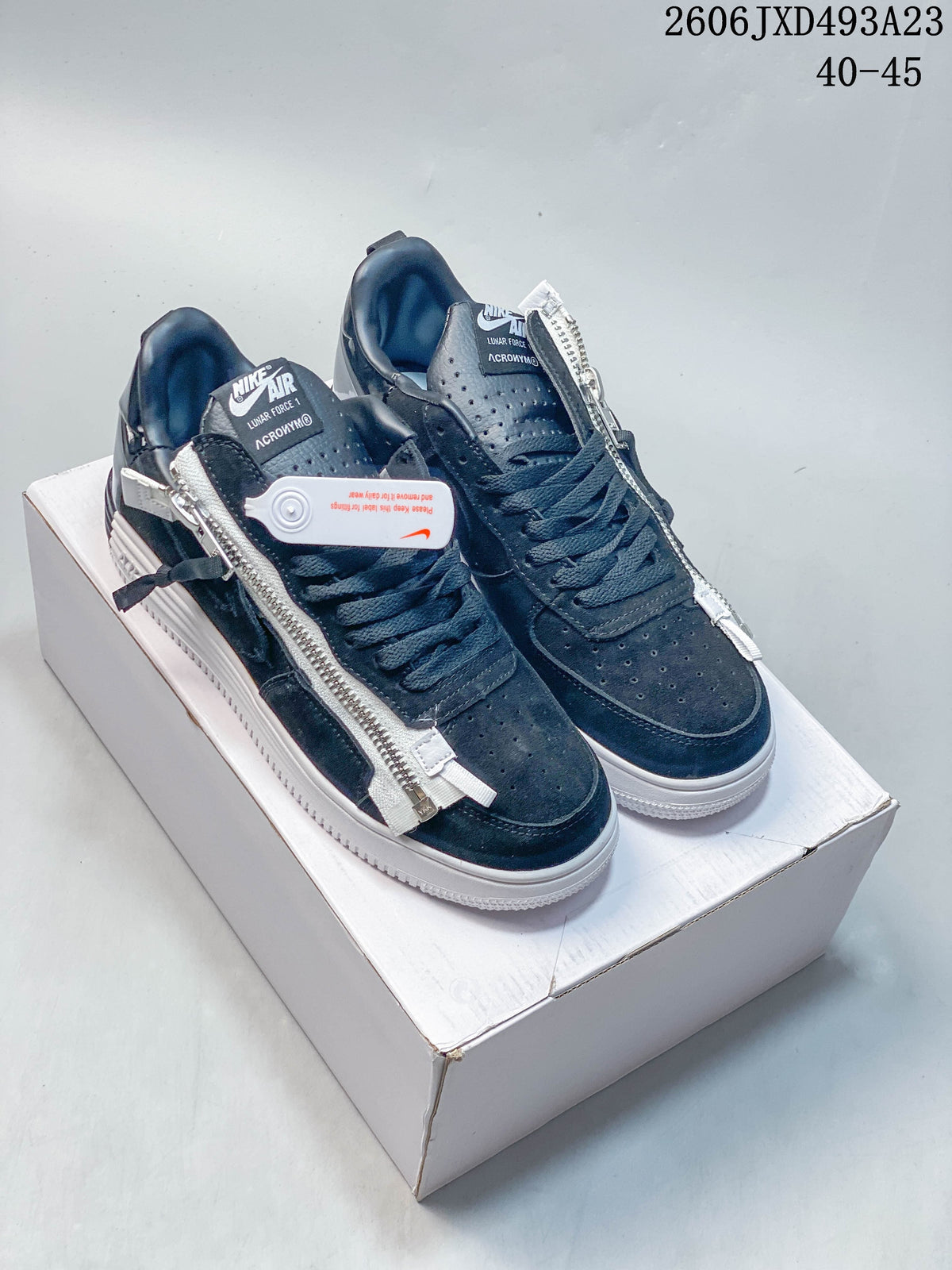 Dark navy low-top sneakers with side zippers and white soles