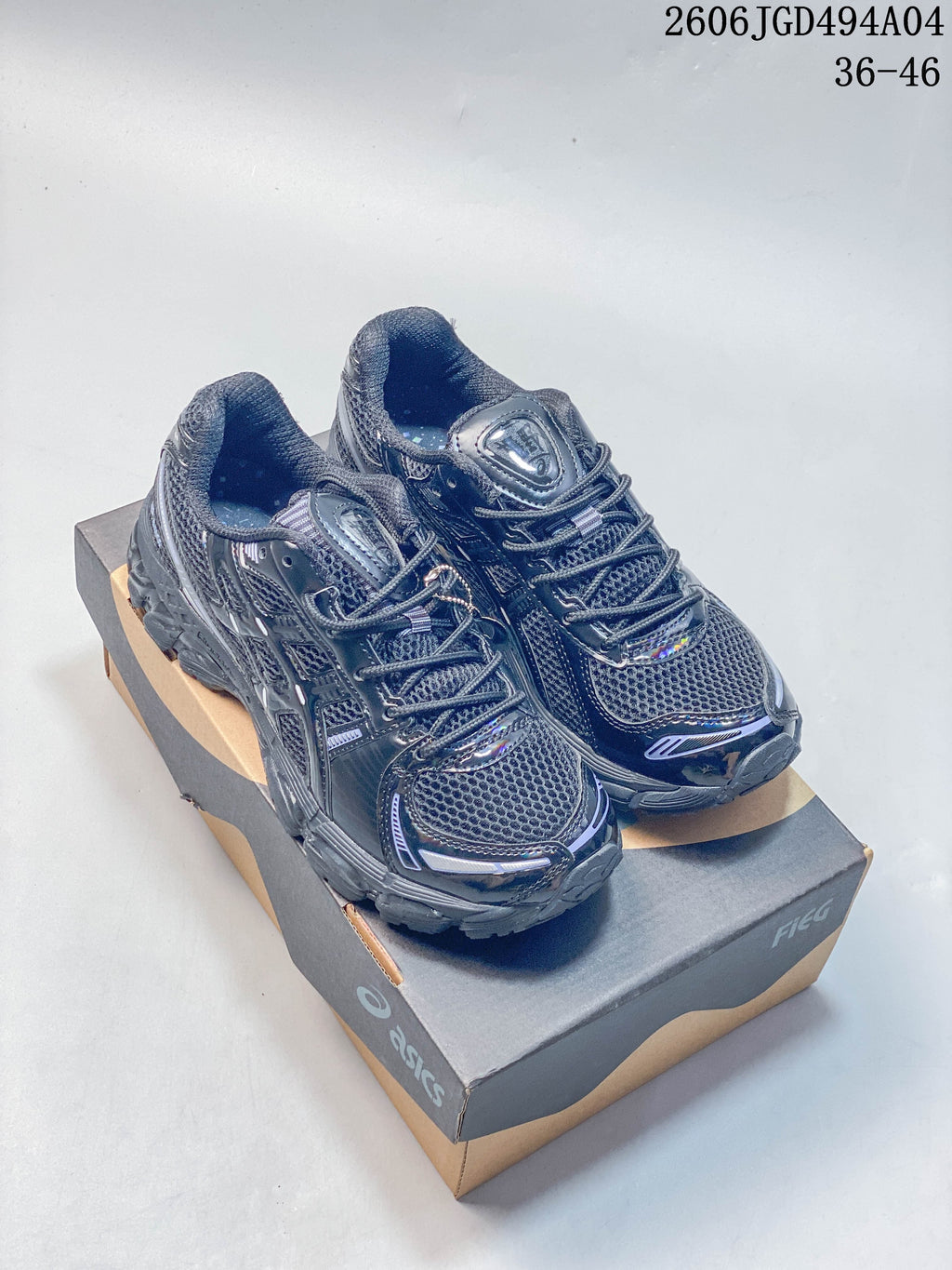 Pair of dark gray ASICS Gel-Kayano 12.1 sneakers shown from above at an angle