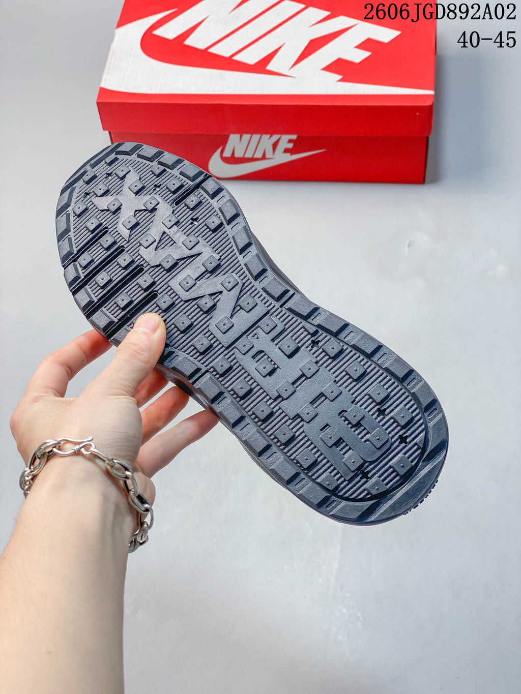 Close-up of the patterned outsole on a dark gray Nike Air Max BIA shoe