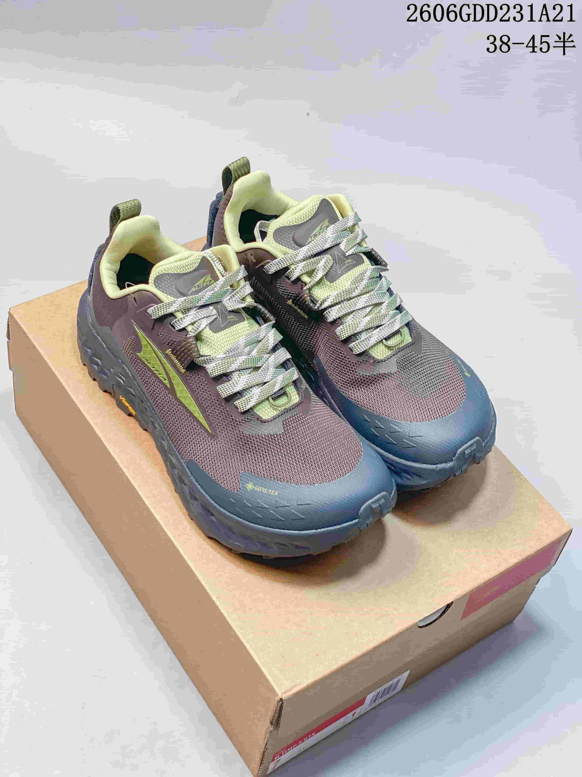 Pair of gray-purple and blue Altra x ROA trail shoes with lime accents, shown on a box