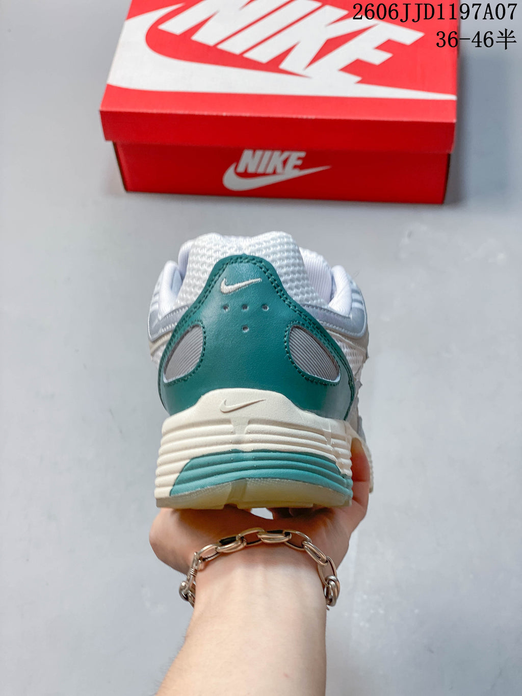 Rear view showing the teal heel panel and ridged midsole