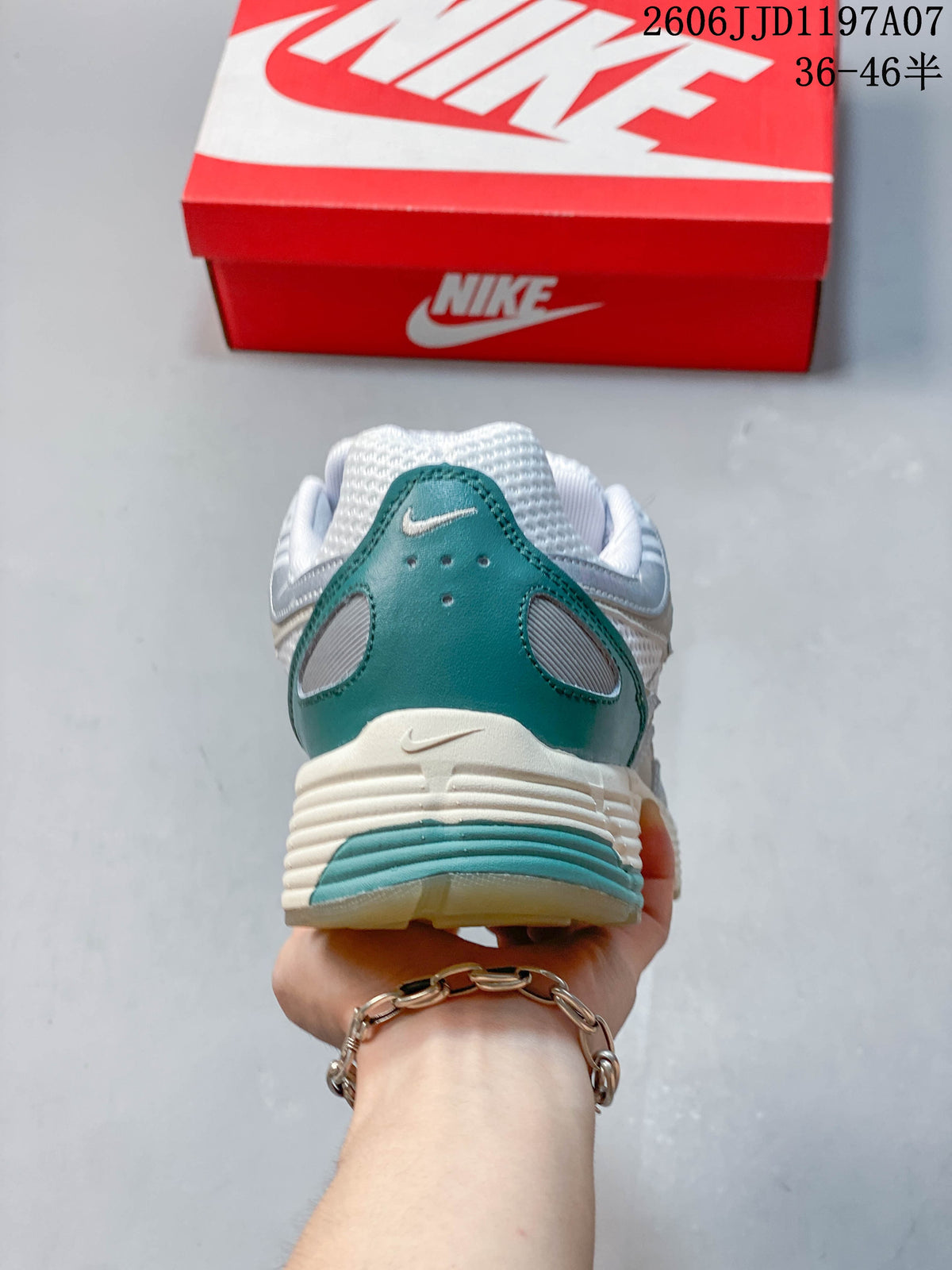 Rear view showing the teal heel panel and ridged midsole