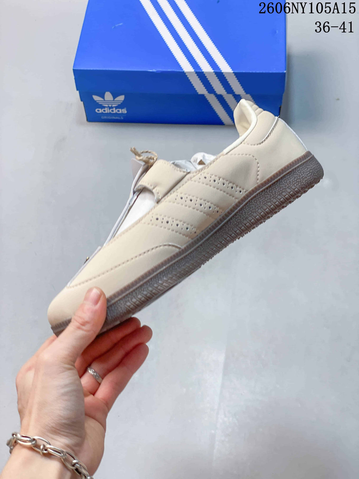 Side profile showing the perforated stripes and gum-colored sole of the beige Samba Jane.