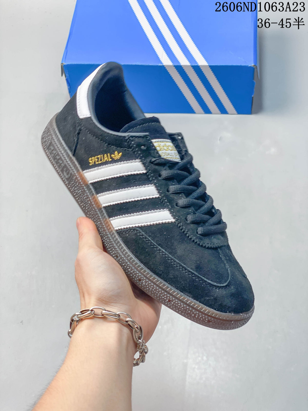 Angled close-up of the navy sneaker with white stripes and gum-colored sole