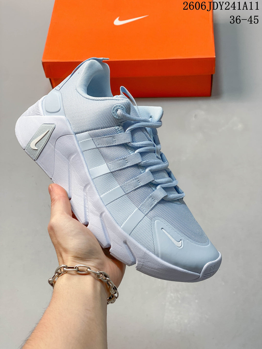 Close-up of a pale blue-gray Nike Free Metcon 7 training shoe with a white sculpted sole.
