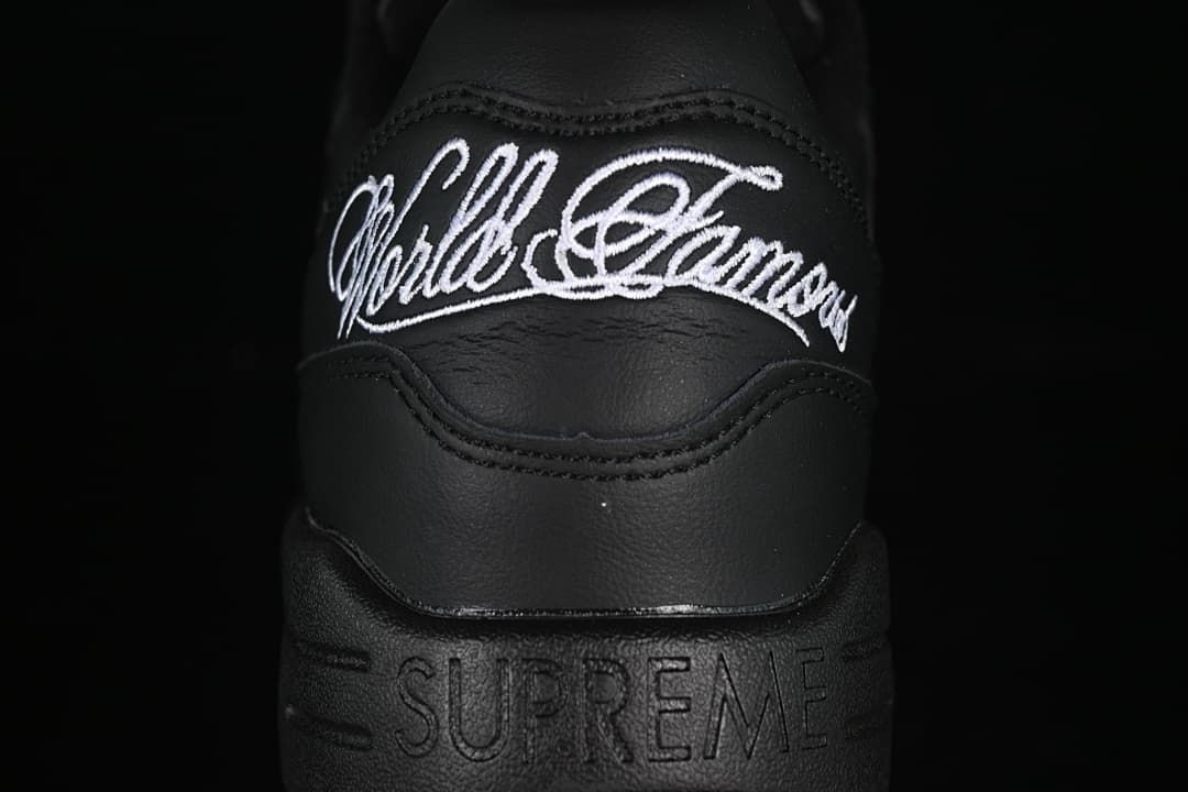 Heel close-up showing white embroidered script and embossed Supreme lettering